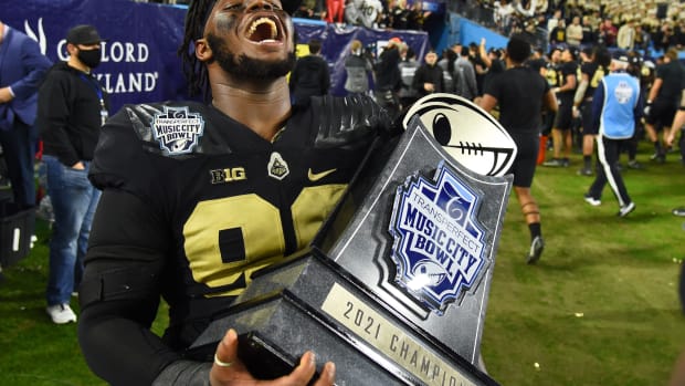 Lawrence Johnson celebrates with the Music City Bowl trophy.